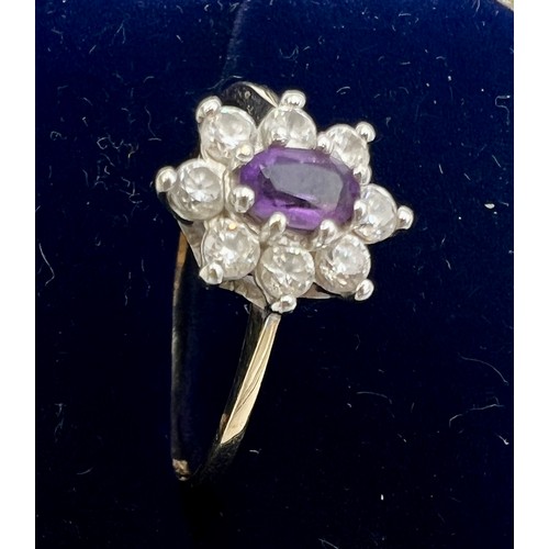 528 - A nine carat gold ring set with purple stone and cubic zirconia. Size R. Weight 1.8gm.