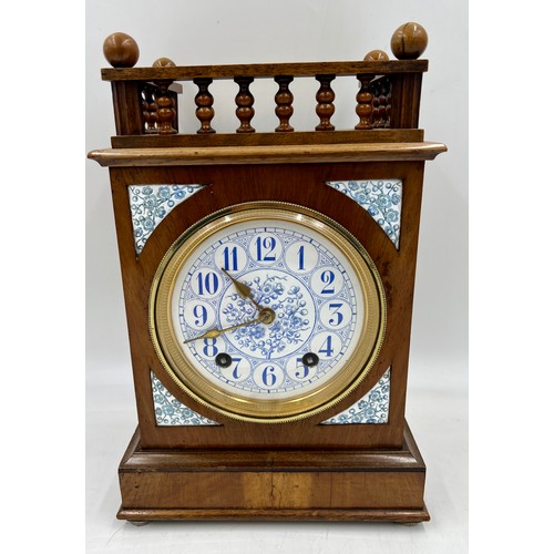 1116 - A 19thC mahogany mantel clock with blue and white ceramic face and inserts. 32cm h.