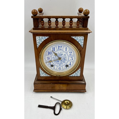 1116 - A 19thC mahogany mantel clock with blue and white ceramic face and inserts. 32cm h.