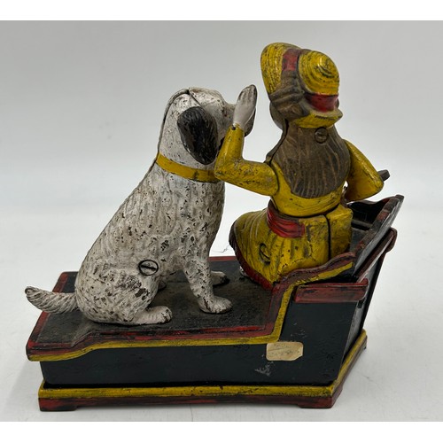 1361 - A cast iron money automated money box, Speaking Dog, 18cm w x 7cm d x 19cm h. Together with a 20thC ... 