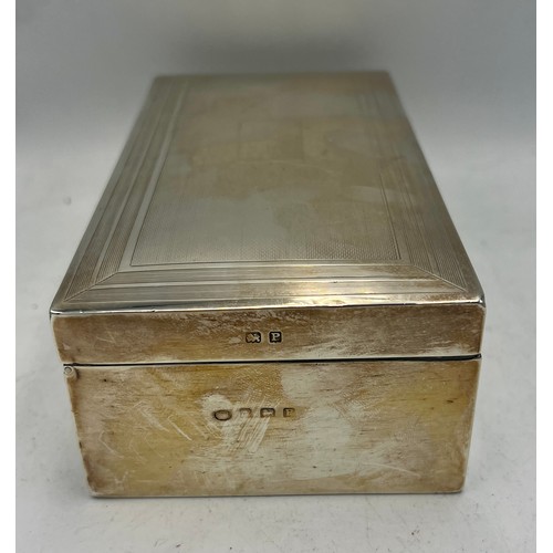 928 - A hallmarked silver cigarette box. 17cm x 8 cm x 5cm h. Birmingham 1939.