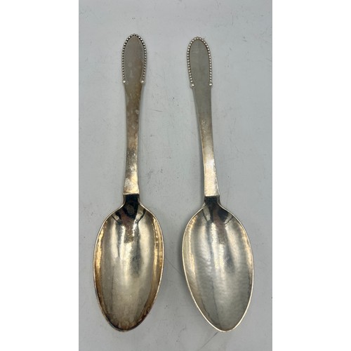 930 - A pair of .925 silver spoons, maker Georg Jensen Weight 129gm. Length 20.5cm.