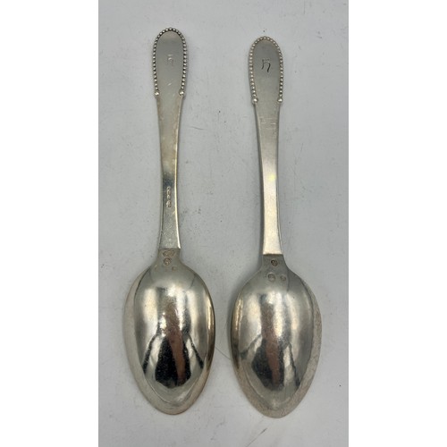 930 - A pair of .925 silver spoons, maker Georg Jensen Weight 129gm. Length 20.5cm.