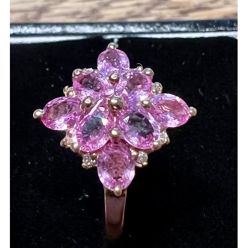 596 - A pink sapphire and diamond cluster ring set in 9 carat rose gold. Size V, weight 2.6gm.