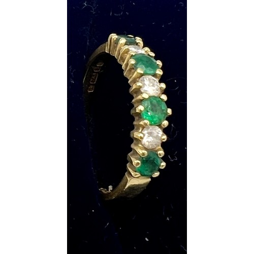 610 - An 18 carat gold emerald and diamond set ring, size M, weight 2.6gm.