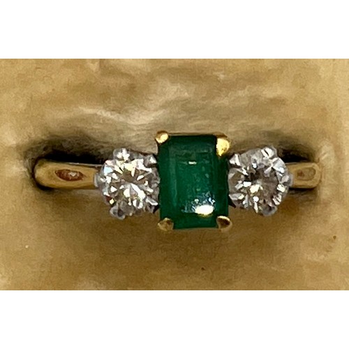 617 - An 18 carat gold emerald and diamond ring, the central emerald with diamond to each side. Size N, we... 