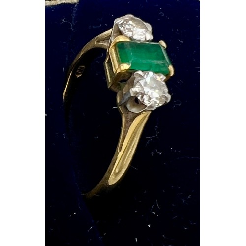 617 - An 18 carat gold emerald and diamond ring, the central emerald with diamond to each side. Size N, we... 