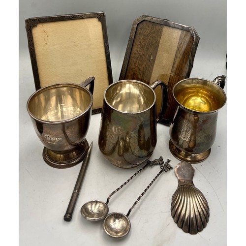 937 - Hallmarked silver to include three mugs, two photograph frames, shell caddy spoon, Mordan Everpoint ... 