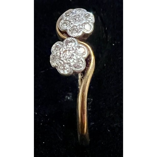 589 - An 18 carat gold and platinum ring set with diamonds in floral cluster setting. Size N. Weight 2.1gm... 