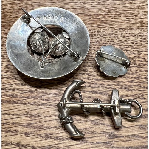 592 - Three silver brooches to include Glasgow 1952, maker Ward Bros, anchor brooch Birmingham 1886 and a ... 