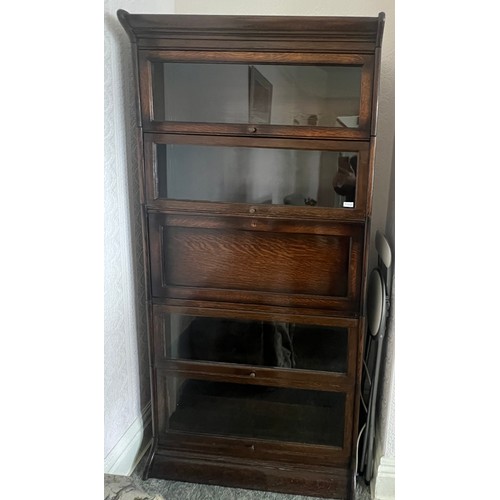 21 - An oak five section globe wernike style bookcase, four glazed sections and one solid door with fitte... 