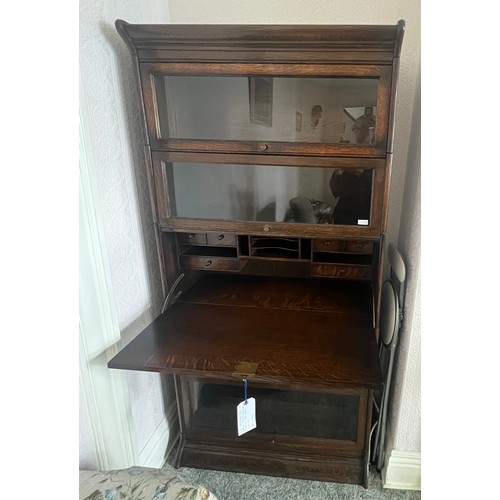 21 - An oak five section globe wernike style bookcase, four glazed sections and one solid door with fitte... 