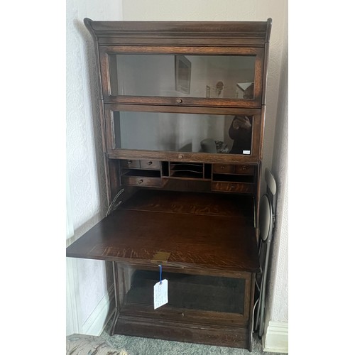 21 - An oak five section globe wernike style bookcase, four glazed sections and one solid door with fitte... 