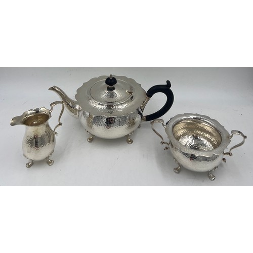 852 - A silver plated three piece tea service.