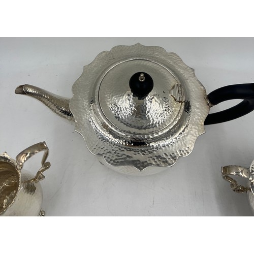 852 - A silver plated three piece tea service.