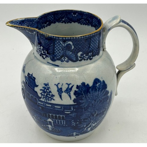 180 - A group of early 19th century blue and white transfer-printed jugs and a mug, c. 1800-10. To include... 