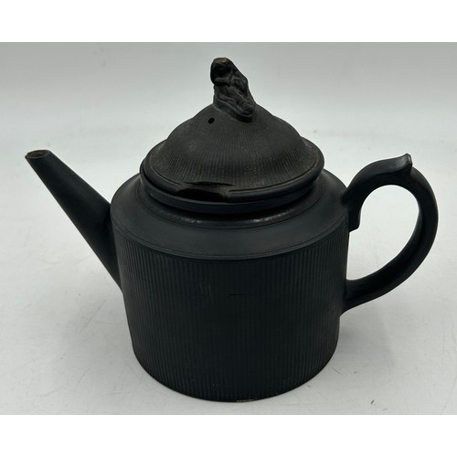 224 - A group of early 19th century black basalt engine turned teapots and covers, one with dog finial c. ... 