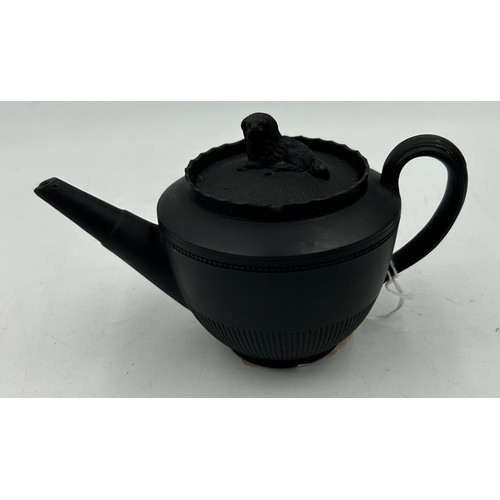 224 - A group of early 19th century black basalt engine turned teapots and covers, one with dog finial c. ... 