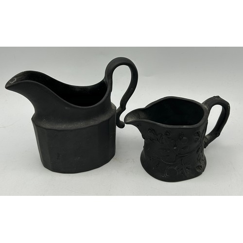 226 - A group of early 19th century black basalt engine turned and moulded creamers and a lidded sugar, c.... 