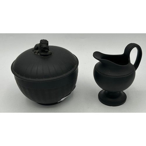 226 - A group of early 19th century black basalt engine turned and moulded creamers and a lidded sugar, c.... 