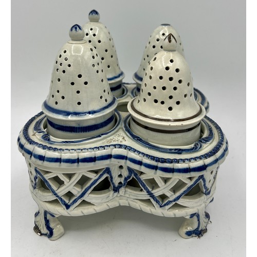 243 - Two early 19th century blue hand-painted pearlware pieces, c. 1810. To include: a cruet set and a te... 