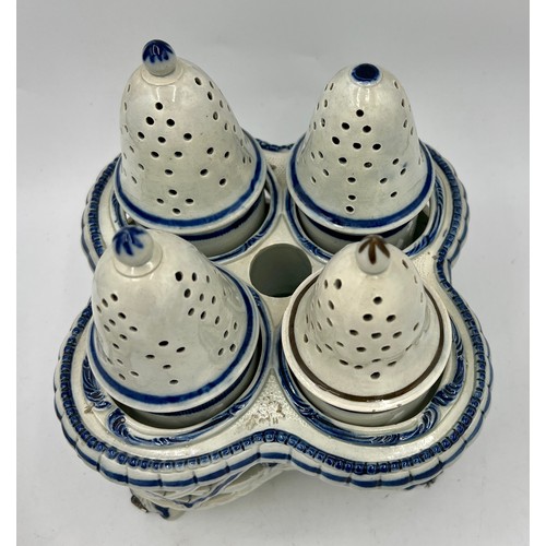 243 - Two early 19th century blue hand-painted pearlware pieces, c. 1810. To include: a cruet set and a te... 