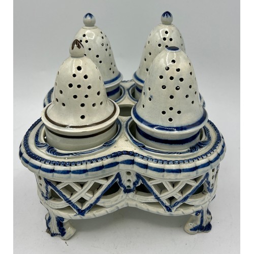 243 - Two early 19th century blue hand-painted pearlware pieces, c. 1810. To include: a cruet set and a te... 