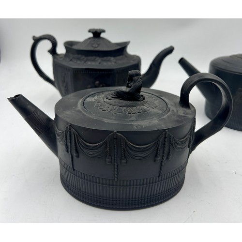 245 - A group of early 19th century black basalt classical design teapots and covers, c. 1810. Tallest: 16... 