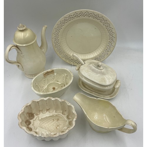 248 - A group of early 19th century creamware, c. 1810. To include: a coffeepot and cover, a sauce boat, t... 