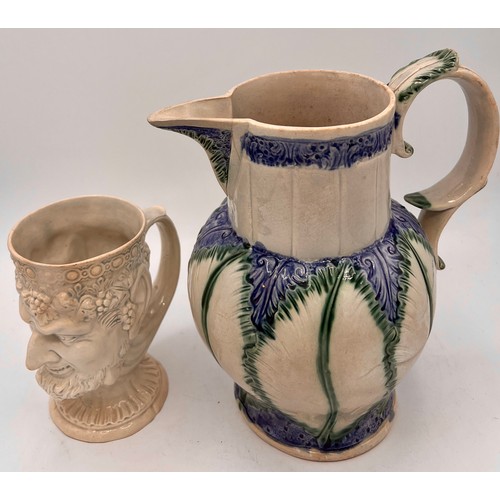 269 - An early 19th century finely-moulded Bacchus jug, together with moulded pearlware leaf-moulded jug, ... 