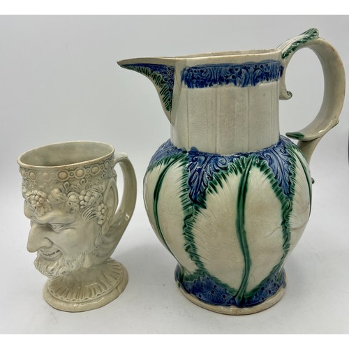 269 - An early 19th century finely-moulded Bacchus jug, together with moulded pearlware leaf-moulded jug, ... 