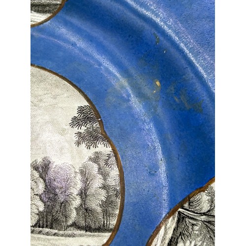 283 - An early 19th century Spode gadrooned plate printed with a scene of Knypersley Hall on a blue ground... 