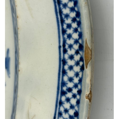 306 - Two early 19th century blue and white hand-painted, shell edge platters, one with a Chinese figure, ... 