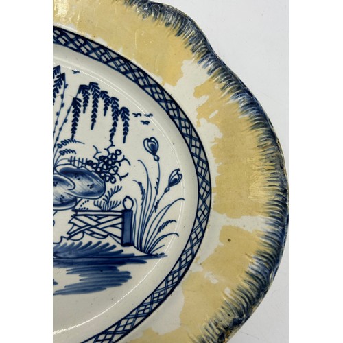 306 - Two early 19th century blue and white hand-painted, shell edge platters, one with a Chinese figure, ... 