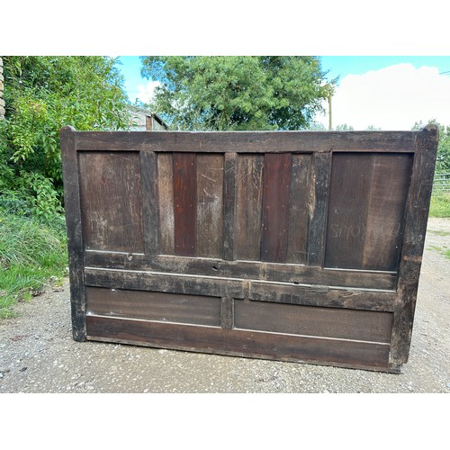 15 - A 18th/19thC oak settle with panelled back and front and lift up seats. 102 h x 152 w x 54cm d appro... 