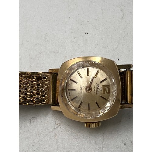 770 - An Oscar ladies 18 carat gold cased wristwatch on a gold plated bracelet. Total weight 21.5gm.