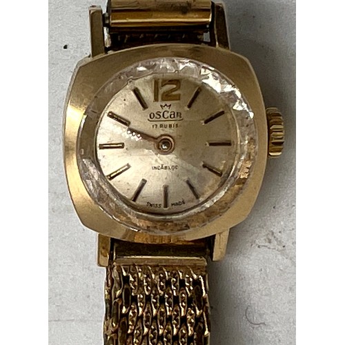 770 - An Oscar ladies 18 carat gold cased wristwatch on a gold plated bracelet. Total weight 21.5gm.