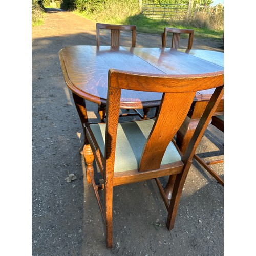 157 - An oak drop leaf table on cabriole legs together with four chairs. 107 w x 150 l (extended) x 74cm h... 