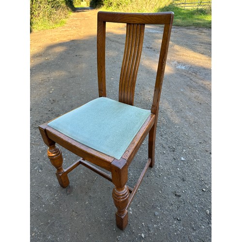 157 - An oak drop leaf table on cabriole legs together with four chairs. 107 w x 150 l (extended) x 74cm h... 