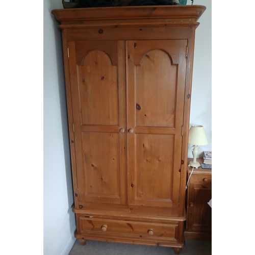 144 - A pine two door wardrobe with single drawer to base. 105cm w x 61cm d x 201cm h.