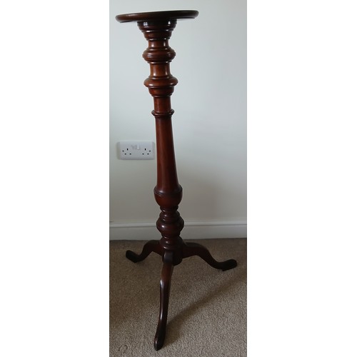 149 - A mahogany torchère with turned column on tripod base. 100cm h.