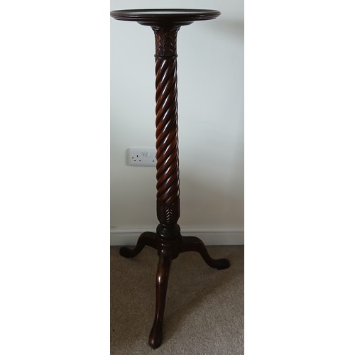 150 - A mahogany torchère with twisted column on tripod base. 105cm h.