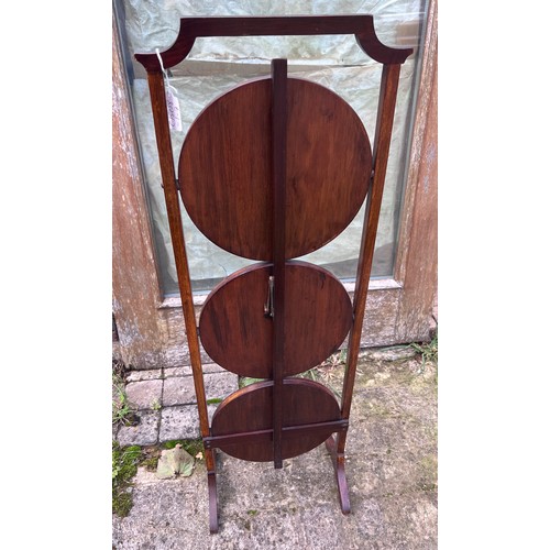 44 - An Edwardian mahogany inlaid folding cake stand with baize to tops. 92cm h.