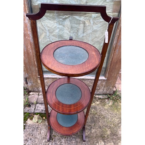 44 - An Edwardian mahogany inlaid folding cake stand with baize to tops. 92cm h.