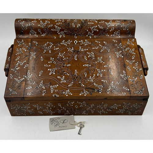 A rosewood inlaid Anglo - Indian Padauk writing slope beautifully worked with bone inlaid Vizagapatam floral designs,  multiple compartments including two secret drawers, ruler etc. With key. 38 w x 27.5d x 18.5cm.