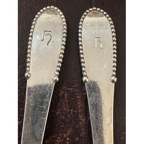 930 - A pair of .925 silver spoons, maker Georg Jensen Weight 129gm. Length 20.5cm.