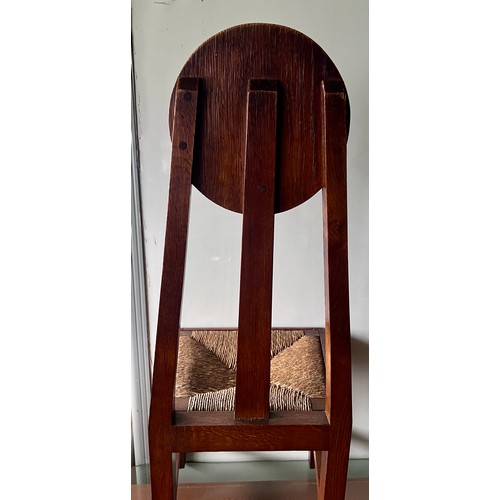 23 - A pair of Arts & Crafts rush seated oak chairs. 98cm h x 41cm w x 38cm d. Height to seat 42cm.