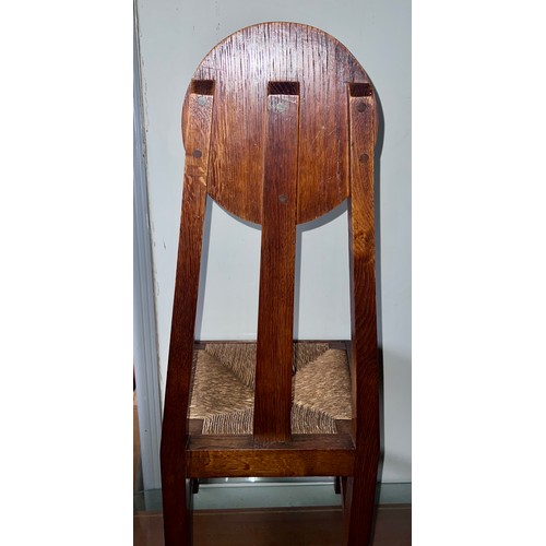 23 - A pair of Arts & Crafts rush seated oak chairs. 98cm h x 41cm w x 38cm d. Height to seat 42cm.