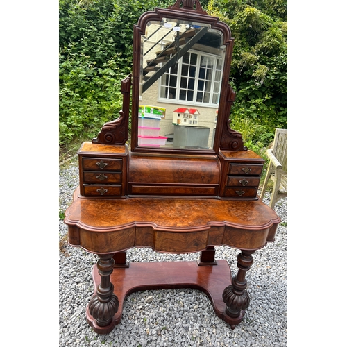 74 - A 19thC figured burr walnut dressing table with frieze drawers, swivel mirror, seven drawers to top ... 