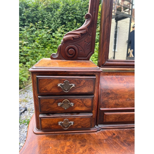 74 - A 19thC figured burr walnut dressing table with frieze drawers, swivel mirror, seven drawers to top ... 